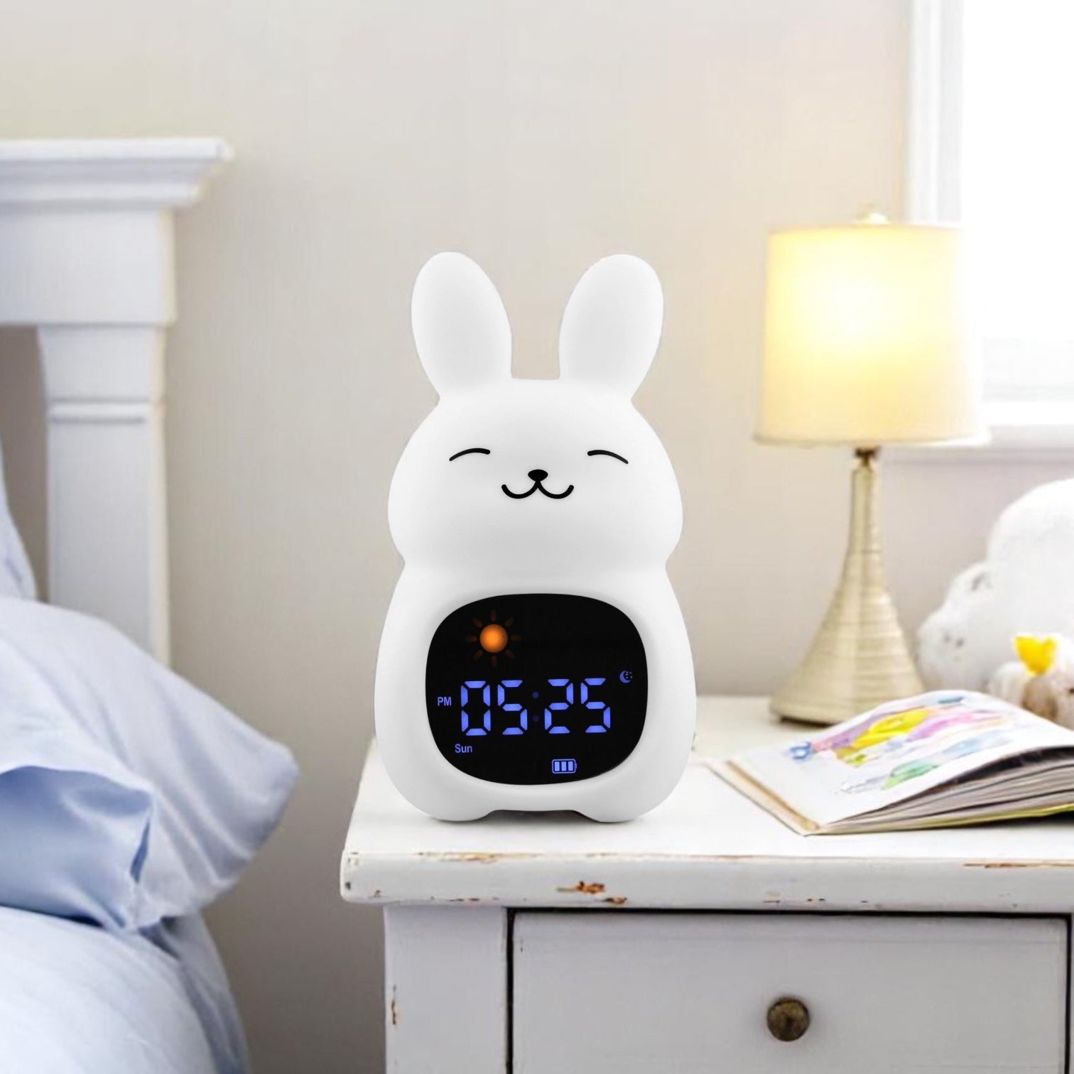 White rabbit-shaped alarm clock on a nightstand next to a bed