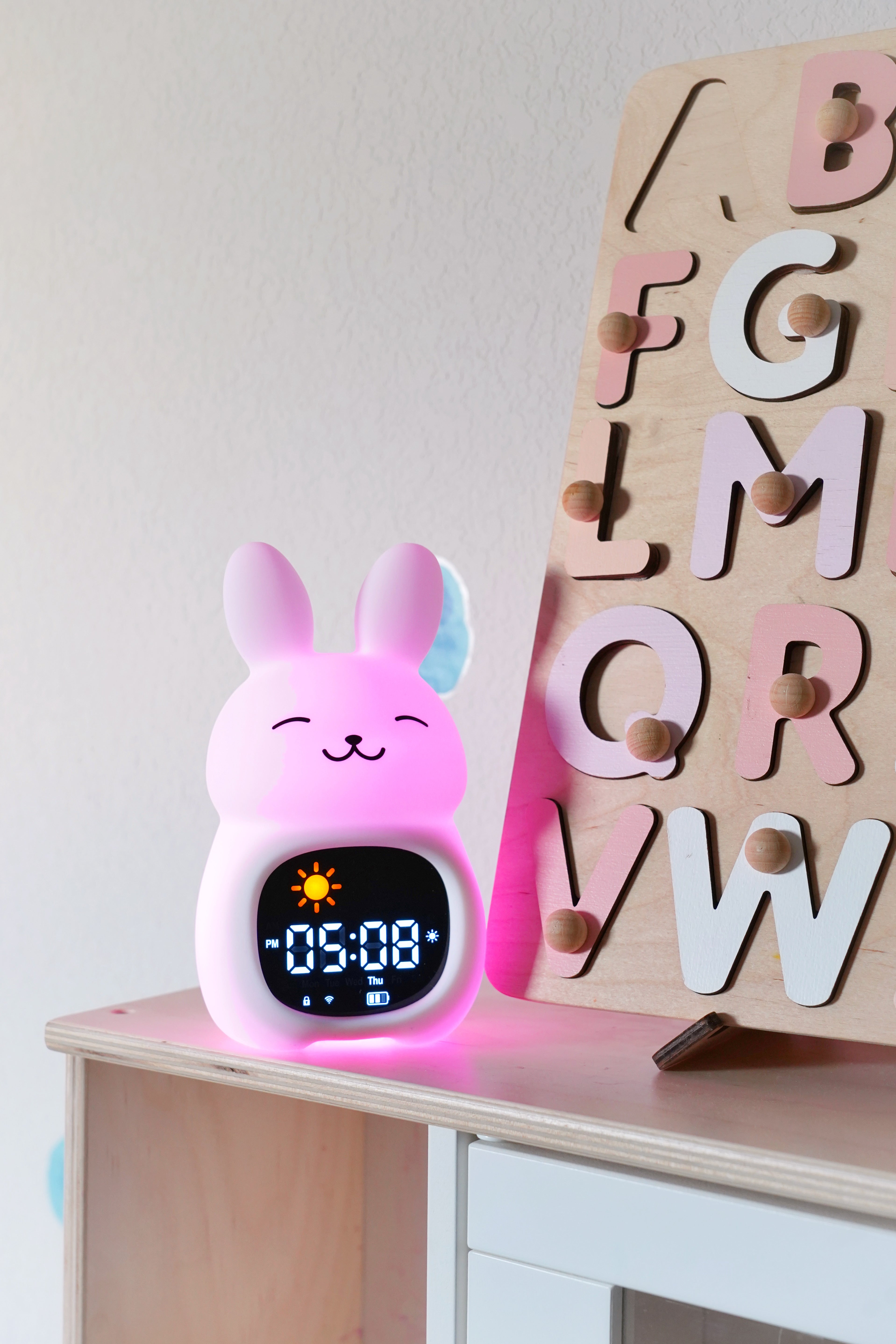 Go &amp; Glow Bunny glowing on a child's bedside shelf